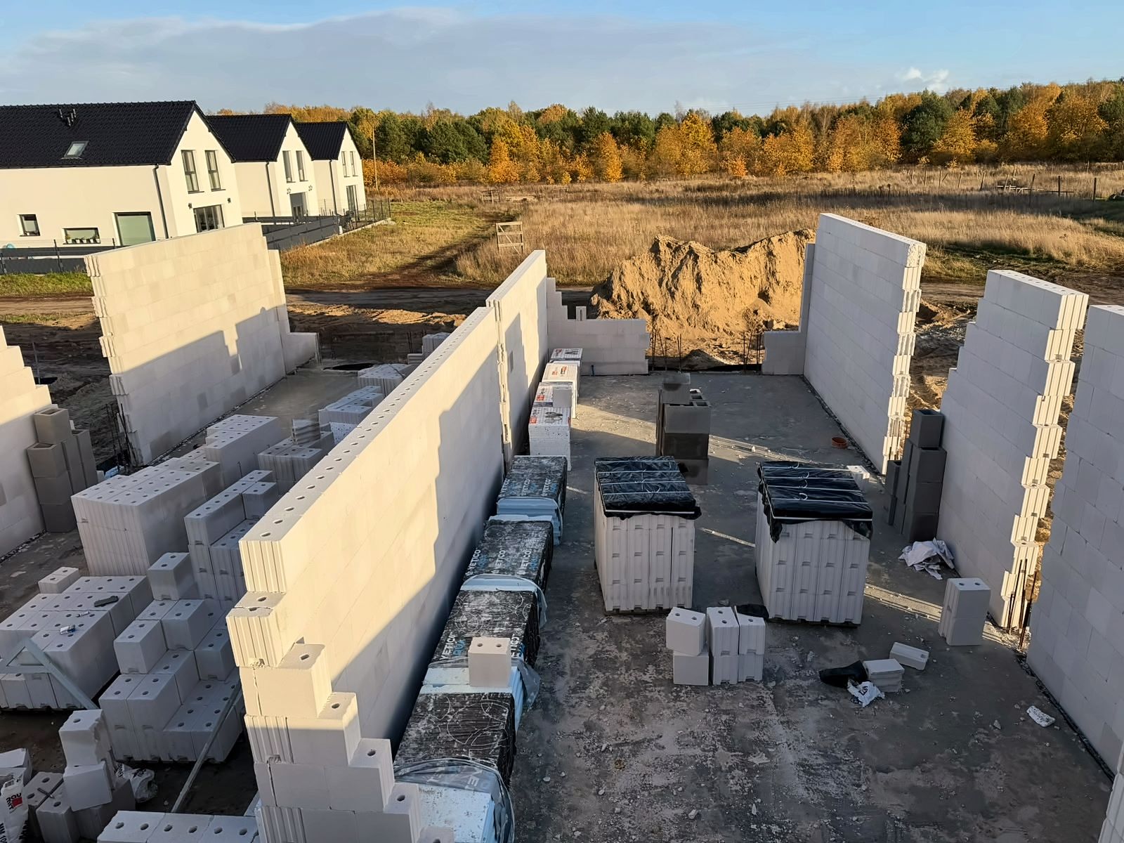 Budowa domu jednorodzinnego koło Stargardu (Lipnik, Morzyczyn) – ściany parteru z bloczków silikatowych, palety bloczków na płycie fundamentowej